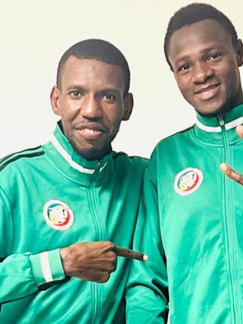 Idrissa Keita, a Para taekwondo athlete from Senegal, and his coach pose for a photograph